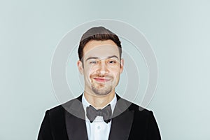 Young handsome man in a tuxedo, looking at the camera